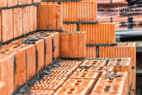 Red ceramic bricks at the construction site. Keramoblock. Hollow brick. Const Stock Photos