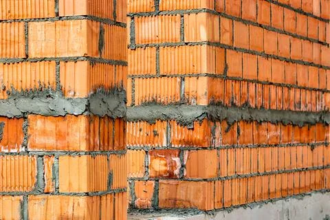 Red ceramic bricks at the construction site. Keramoblock. Hollow brick. Const Stock Photos
