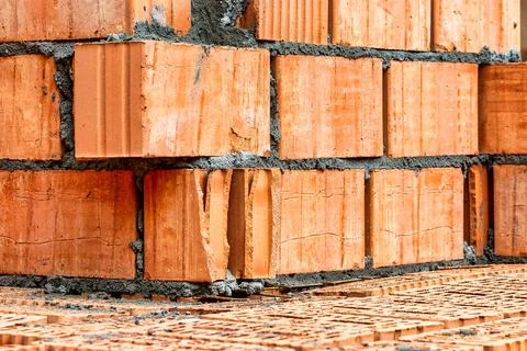 Red ceramic bricks at the construction site. Keramoblock. Hollow brick. Const Stock Photos