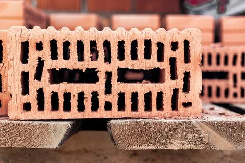 Red ceramic bricks at the construction site. Keramoblock. Hollow brick. Const Stock Photos