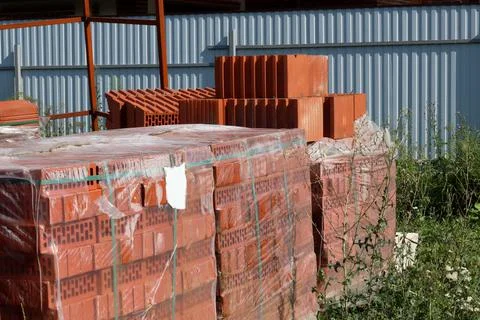 Red ceramic bricks in packaging at a construction site. Keramoblock Stock Photos