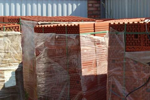 Red ceramic bricks in packaging at a construction site. Keramoblock. Good qua Stock Photos