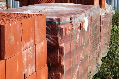 Red ceramic bricks in packaging at a construction site. Keramoblock Stock Photos