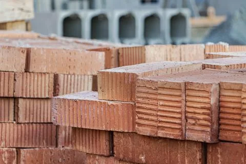 Red ceramic bricks stacked on a construction site. Construction Materials. Stockfoto's