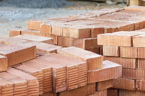 Red ceramic bricks stacked on a construction site. Construction Materials. 写真素材