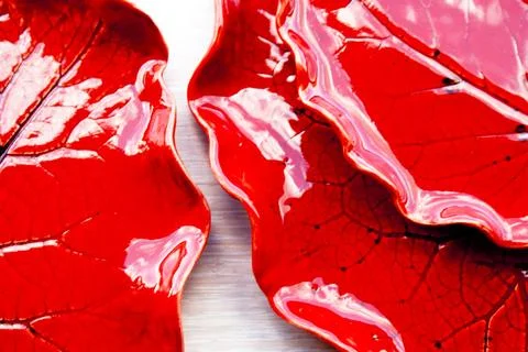 Red ceramic plates with leaf imprint glossy glaze texture Stock Photos