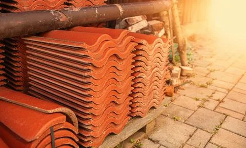 Red ceramic roof tiles stack in backyard.High quality photo Stock Photos