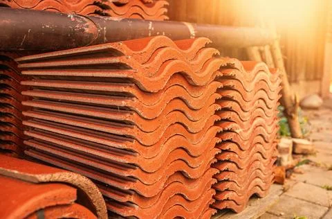 Red ceramic roof tiles stack in backyard.High quality photo Stock Photos