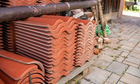 Red ceramic roof tiles stack in backyard.High quality photo Stock Photos
