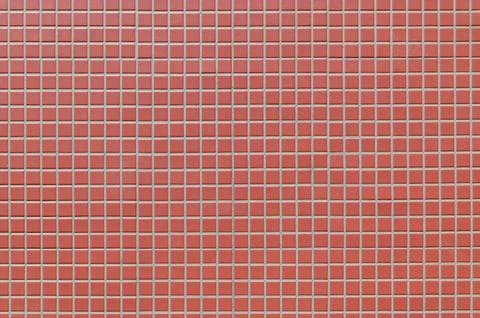 Red ceramic tile wall with uniform square grout grid Stock Photos