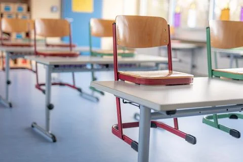 Red chair in a classroom stands on a table Stock Photos