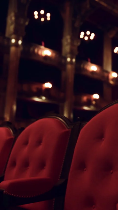 Red chairs in an old theater with lights shining in the background Stock Footage 337943502