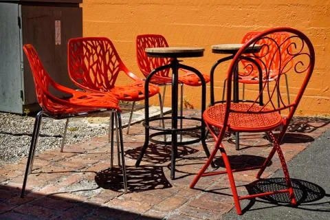 Red chairs stackable and collapsible in a cafe garden, New Zealand. Stock-Fotos
