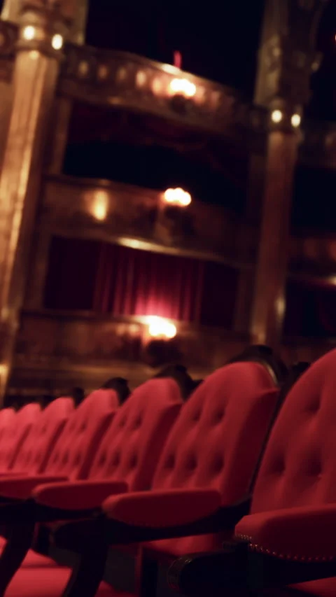 Red chairs in a theater before a performance starts in the evening Stock Footage 337941275