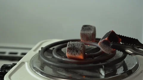 Red charcoal for hookahs, turned over on an electric stove Stock-Footage 255274354