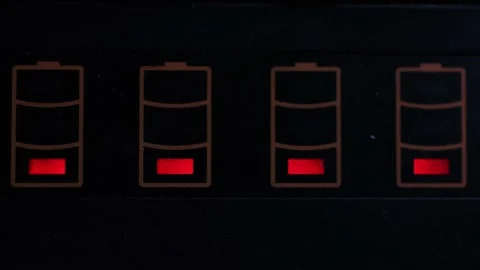 Red charging indicator battery lights blinking on black background Stock Footage 156224817