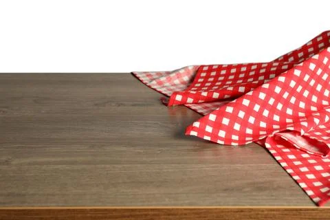 Red checkered tablecloth on wooden table against white background, closeup Stock Photos