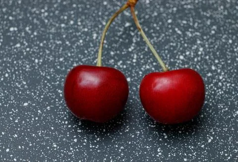 Red cherries on an abstract background are small, juicy fruits of a bright .. Stock Photos