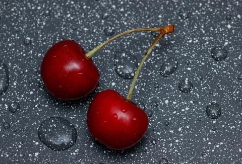 Red cherries on an abstract background are small, juicy fruits of a bright .. Stock Photos