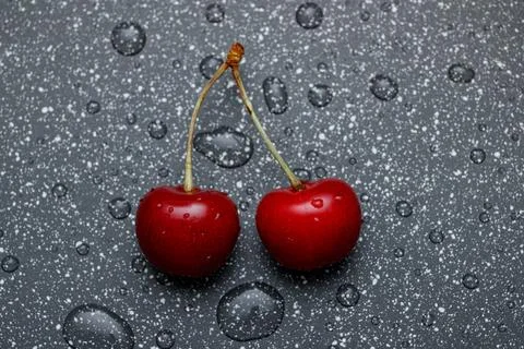 Red cherries on an abstract background are small, juicy fruits of a bright .. Stock Photos