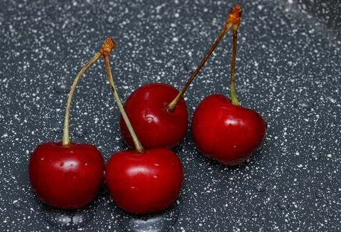 Red cherries on an abstract background are small, juicy fruits of a bright .. Stock Photos