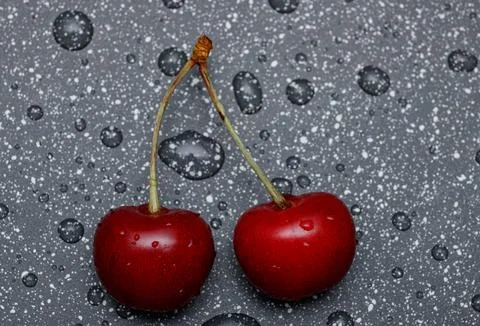 Red cherries on an abstract background are small, juicy fruits of a bright .. Stock Photos