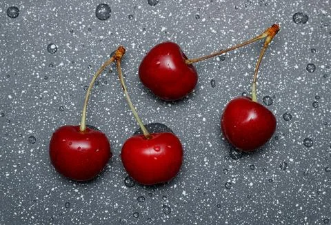 Red cherries on an abstract background are small, juicy fruits of a bright .. Stock Photos