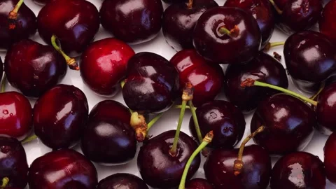 Red cherries turn slowly on table. Delicious cherries look juicy and sweet. Stock Footage 312002698