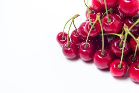 Red cherries on a white background. Sweet cherry with tails. Stock Photos