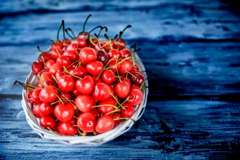Red cherries on a wooden table Stock Photos