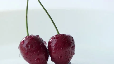 Red cherry berries in water drops on a white background. Macro video, juicy Stock Footage 198251576
