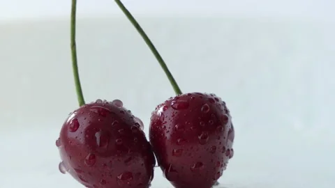 Red cherry berries in water drops on a white background. Macro video, juicy Stock Footage 201881246