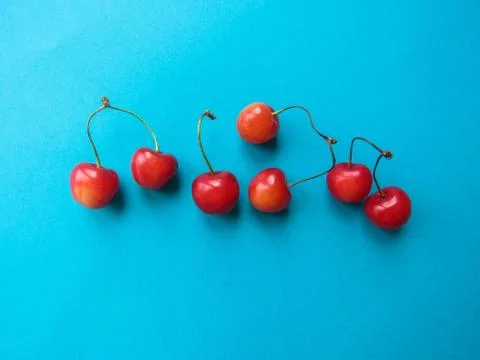 Red cherry on a blue table Stock Photos