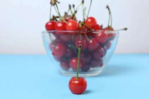 Red cherry cherry close-up on the back background of a bowl of cherries. Seas Stock Photos