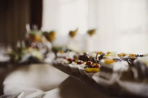 Red cherry decorated sweets on buffet tables , cocktails party Stock Photos