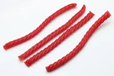 Red Cherry Flavored Licorice assorted candy group pile on white background Stock Photos