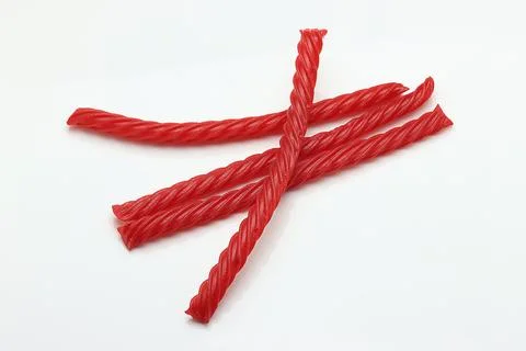 Red Cherry Flavored Licorice assorted candy group pile on white background Stock Photos