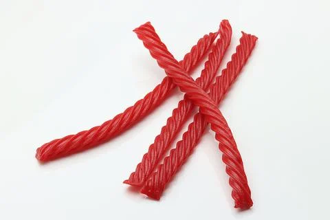 Red Cherry Flavored Licorice assorted candy group pile on white background Stock Photos