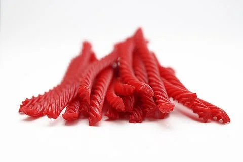 Red Cherry Flavored Licorice assorted candy group pile on white background Stock Photos