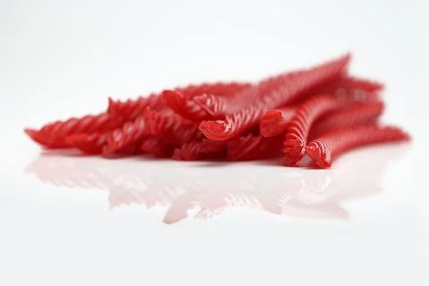 Red Cherry Flavored Licorice assorted candy group pile on white background Stock Photos
