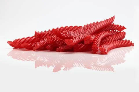 Red Cherry Flavored Licorice assorted candy group pile on white background Stock Photos