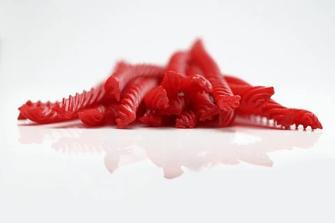Red Cherry Flavored Licorice assorted candy group pile on white background Stock Photos