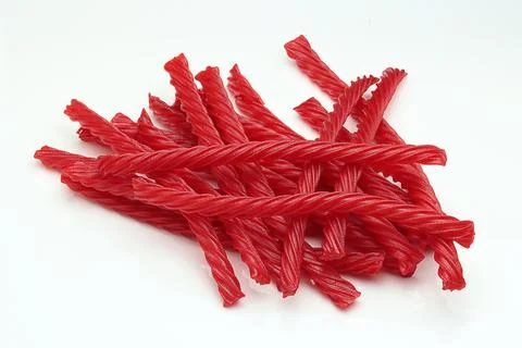 Red Cherry Flavored Licorice assorted candy group pile on white background Stock Photos