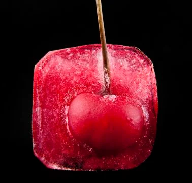 Red cherry is in ice Stock Photos