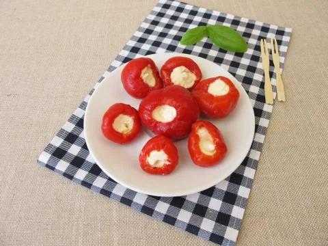 Red cherry pepper stuffed with fresh cheese Stock Photos