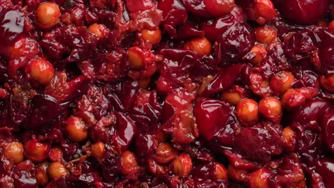 Red cherry pits and pulp after squeezing out juice as a background, rotates Stock Footage 318874977