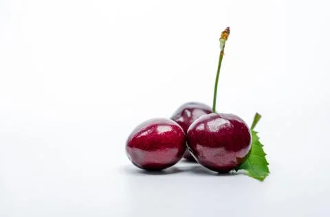 Red cherry with stalk and leaf isolated on white background. Ripe red sweet c 스톡 사진