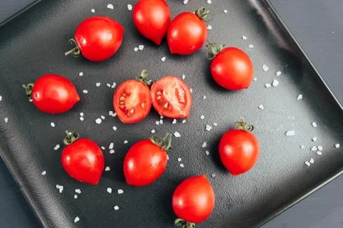 Red cherry tomatoes on dark background many Stock Photos