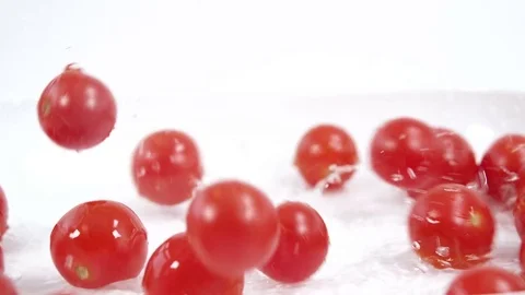 Red cherry tomatoes falling in slow motion Stock Footage 72512324