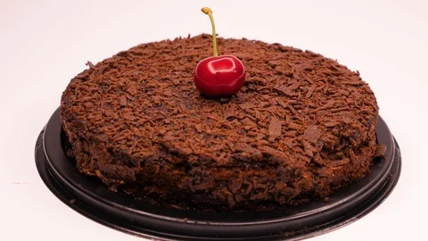 Red cherry topping on chocolate cake Stock Footage 101583697
